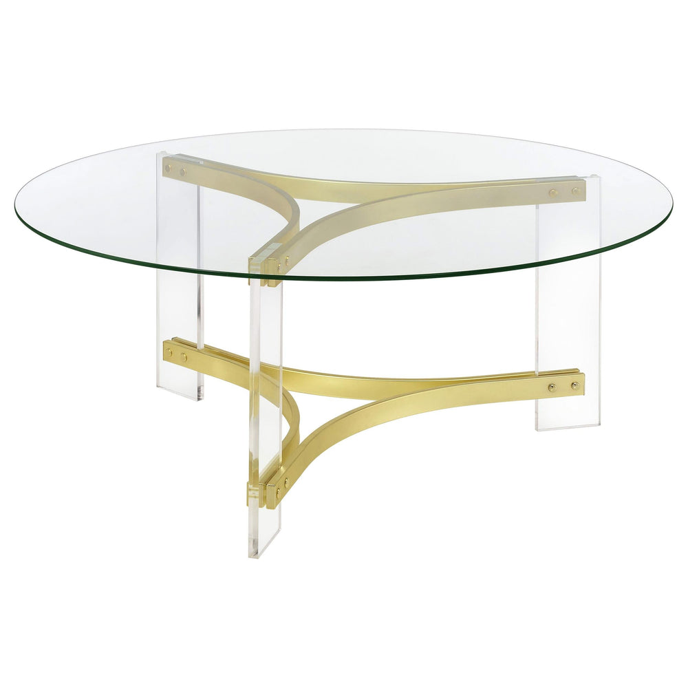Mesa de centro Janessa redonda con tapa de vidrio y patas acrílicas, latón mate