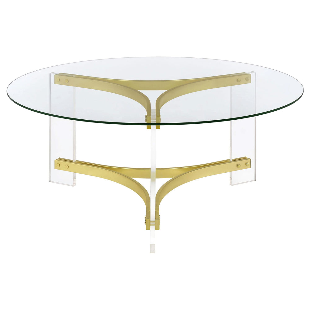 Mesa de centro Janessa redonda con tapa de vidrio y patas acrílicas, latón mate