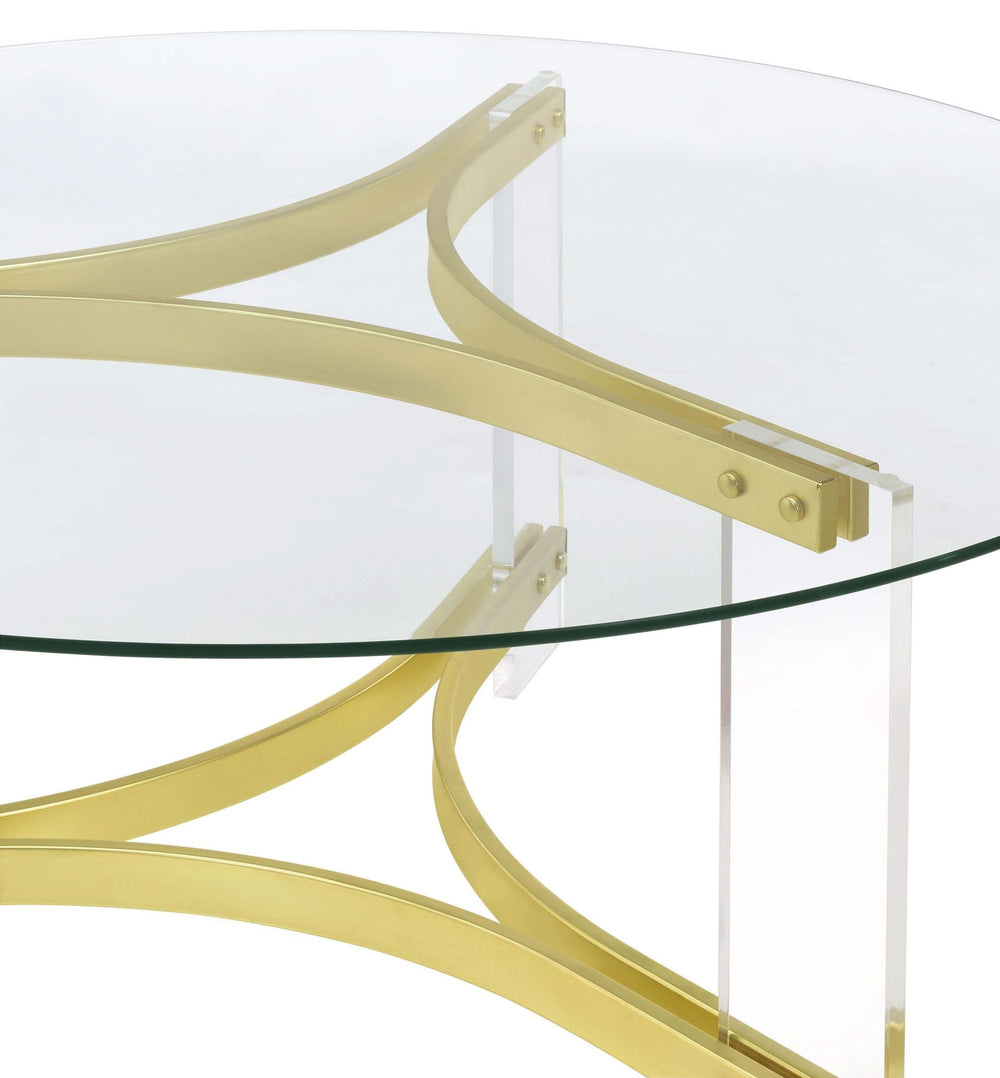 Mesa de centro Janessa redonda con tapa de vidrio y patas acrílicas, latón mate