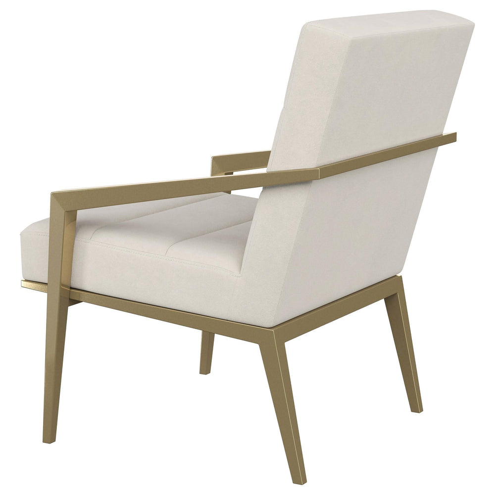 Sillón decorativo Kirra con brazos de metal tapizados en color crema