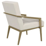 Sillón decorativo Kirra con brazos de metal tapizados en color crema