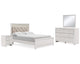 Cama Queen Altyra con paneles tapizados, tocador, espejo y mesita de noche